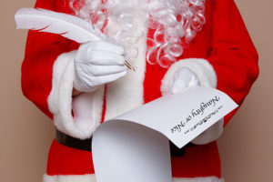 bigstock-Santa-Claus-holding-a-quill-pe-39548263