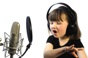 little girl engrossed in recording a song